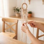 Beginner making a macrame plant hanger with cotton cord and wooden ring