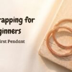 Wire wrapping for beginners flat lay with copper wire, pliers, and a tumbled stone.