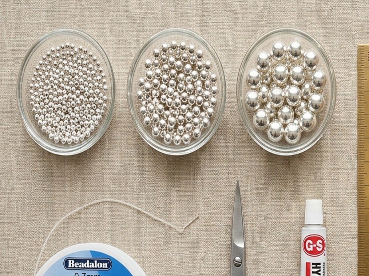 Macro close-up comparison of 3mm, 4mm, and 6mm sterling silver round beads in glass dishes for bracelet stacking