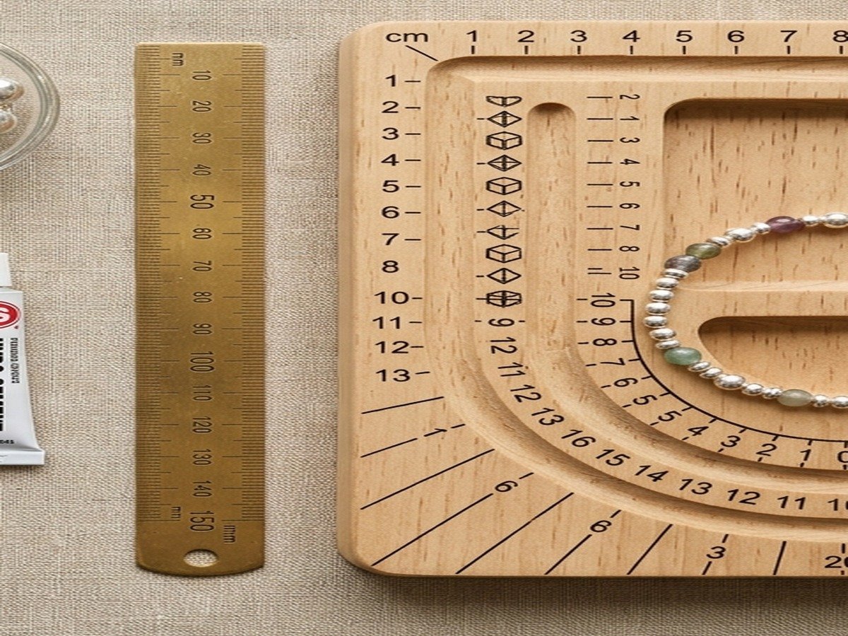 Wooden bead design and sizing board showing bracelet circumference channels and millimeter measurements